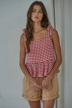 Load image into Gallery viewer, Woman wearing a red and white checkered top and beige shorts against a plain background