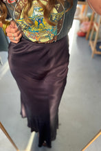 Load image into Gallery viewer, Person wearing a graphic t-shirt and dark skirt indoors