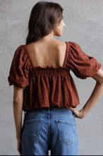Load image into Gallery viewer, Woman wearing a brown textured top and blue jeans against a gray background
