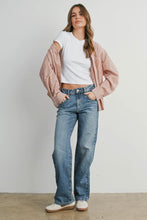 Load image into Gallery viewer, Woman wearing a white shirt, striped pink and white jacket, and blue jeans against a plain background