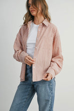 Load image into Gallery viewer, Woman wearing a striped shirt and jeans on a plain background