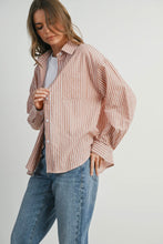 Load image into Gallery viewer, Woman wearing a striped shirt and jeans on a plain background