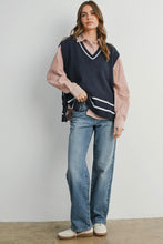 Load image into Gallery viewer, Woman wearing a navy sweater vest over a striped shirt with blue jeans against a plain background