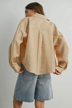 Load image into Gallery viewer, Person wearing a beige striped shirt and denim shorts on a plain background