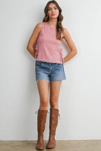 Load image into Gallery viewer, Woman wearing a red and white checkered top, denim shorts, and brown knee-high boots against a white wall.