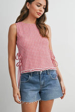 Load image into Gallery viewer, Woman wearing a red and white checkered sleeveless top and denim shorts on a plain background