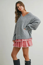 Load image into Gallery viewer, Woman wearing a gray sweater and red plaid skirt with black boots on a plain background