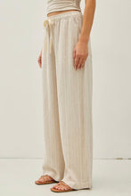 Load image into Gallery viewer, Person wearing beige wide-leg pants on a white background