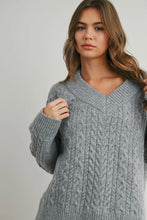Load image into Gallery viewer, Woman wearing a gray cable knit sweater against a plain background