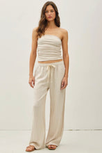 Load image into Gallery viewer, Woman wearing a strapless top and wide-leg pants on a white background