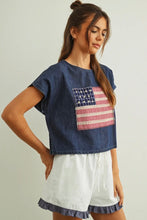 Load image into Gallery viewer, Woman wearing a denim shirt with an American flag design on a plain background