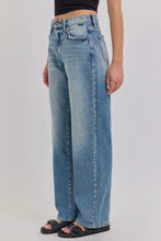 Load image into Gallery viewer, Person wearing light blue jeans on a plain background