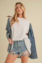 Load image into Gallery viewer, Woman wearing a white sweater, denim jacket, and shorts on a beige background