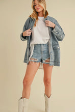 Load image into Gallery viewer, Woman wearing a denim jacket, white shirt, and shorts on a beige background