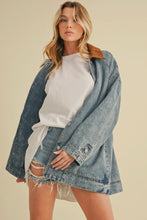 Load image into Gallery viewer, Woman wearing a denim jacket over a white top and shorts on a beige background