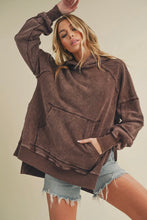 Load image into Gallery viewer, Woman wearing a brown oversized hoodie and denim shorts against a neutral background
