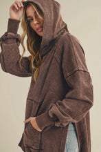 Load image into Gallery viewer, Woman wearing a brown hoodie with a neutral background