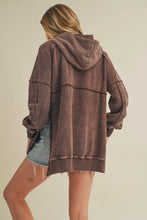 Load image into Gallery viewer, Person wearing a brown hoodie with a beige background