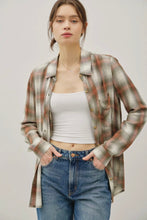 Load image into Gallery viewer, Woman wearing a plaid shirt over a white top and blue jeans on a plain background