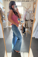 Load image into Gallery viewer, Woman taking a mirror selfie wearing a checkered top and blue jeans in a store.