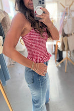 Load image into Gallery viewer, Woman taking a mirror selfie wearing a red checkered top and blue jeans in a store.