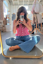 Load image into Gallery viewer, Person taking a mirror selfie wearing a pink top and blue jeans in a store.