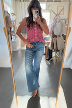 Load image into Gallery viewer, Person taking a mirror selfie wearing a red checkered top and blue jeans in a store.