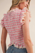 Load image into Gallery viewer, Woman wearing a pink and white checkered top with ruffled details on a beige background