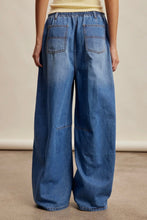 Load image into Gallery viewer, Wide-leg blue jeans worn by a person on a neutral background