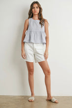 Load image into Gallery viewer, Woman wearing a sleeveless checkered top and white shorts against a plain background