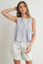Load image into Gallery viewer, Woman wearing a checkered top and white shorts against a plain background