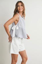 Load image into Gallery viewer, Woman wearing a checkered top and white shorts on a plain background