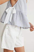 Load image into Gallery viewer, Person wearing a checkered top with a bow and white shorts on a plain background
