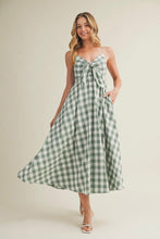 Load image into Gallery viewer, Woman wearing a green and white checkered dress against a beige background