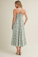 Load image into Gallery viewer, Woman wearing a green and white checkered dress on a beige background