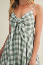 Load image into Gallery viewer, Green and white checkered dress with a knot detail on a neutral background