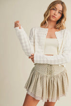 Load image into Gallery viewer, Woman wearing a white knit cardigan over a beige top and patterned skirt on a plain background