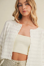 Load image into Gallery viewer, Woman wearing a white textured cardigan over a cream-colored top with a neutral background