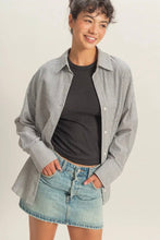 Load image into Gallery viewer, Woman wearing a striped shirt over a black top and denim shorts on a plain background