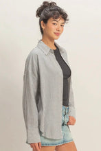Load image into Gallery viewer, Woman wearing a striped shirt over a black top with denim shorts on a plain background