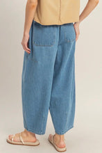 Load image into Gallery viewer, Person wearing blue jeans and a beige top on a plain background