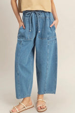Load image into Gallery viewer, Person wearing blue denim pants on a plain background