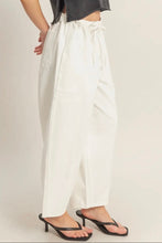 Load image into Gallery viewer, Person wearing white pants and black sandals on a plain background
