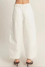 Load image into Gallery viewer, White wide-leg pants worn by a person on a plain background