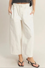 Load image into Gallery viewer, Person wearing white wide-leg pants with a plain background