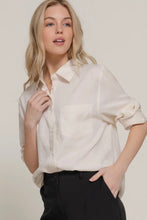 Load image into Gallery viewer, Woman wearing a light-colored blouse and black pants against a plain background