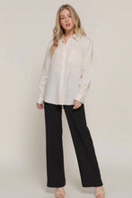 Load image into Gallery viewer, Woman wearing a white blouse and black pants on a plain background