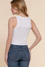 Load image into Gallery viewer, Woman wearing a white tank top and blue jeans on a beige background