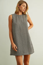 Load image into Gallery viewer, Woman wearing a black and white checkered dress against a plain background