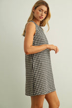 Load image into Gallery viewer, Woman wearing a black and white checkered dress on a plain background